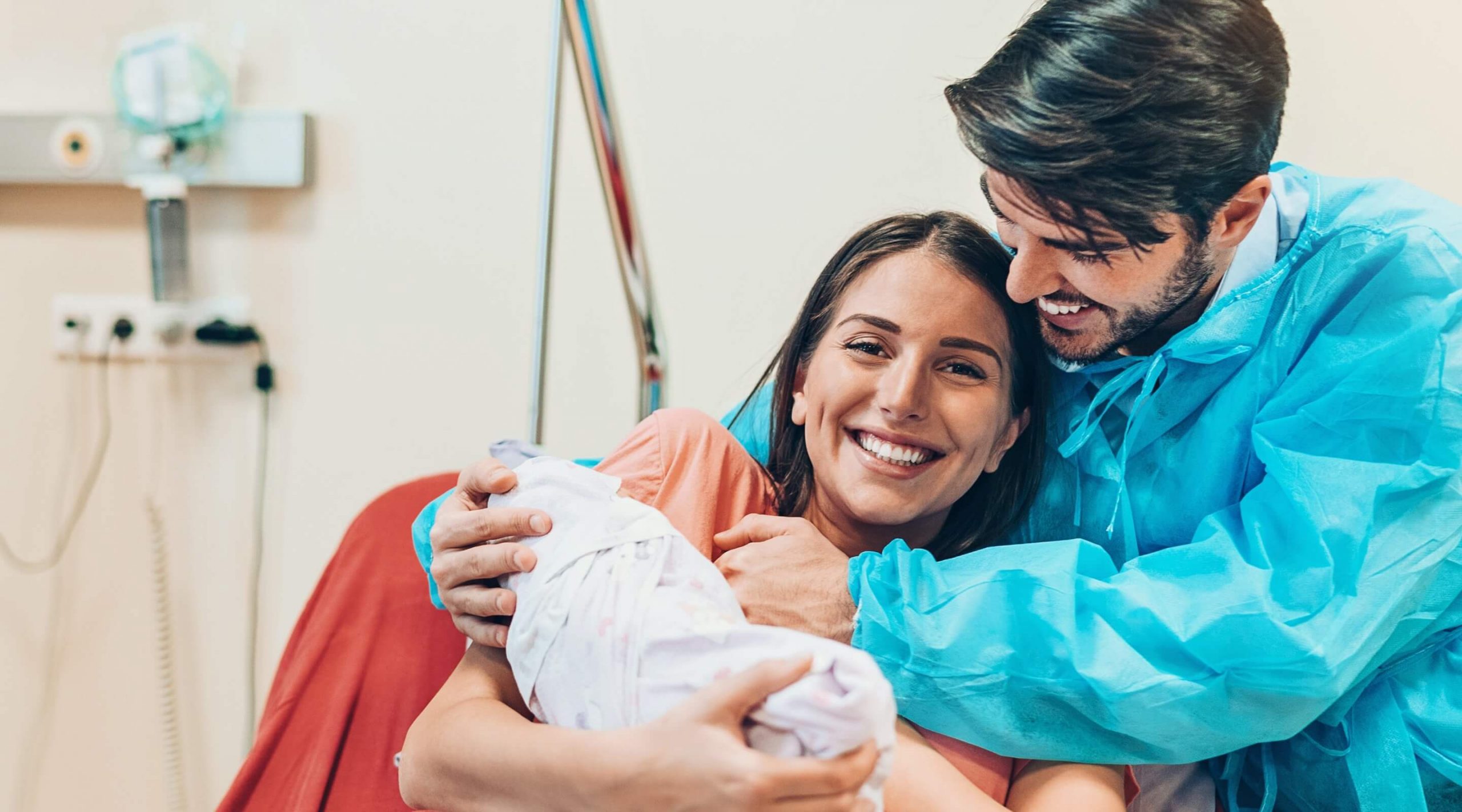 Happy couple holding newborn baby