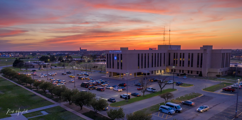 Hutchinson Regional Medical Center main building with a beautiful orange, yellow, purple, and blue sunset