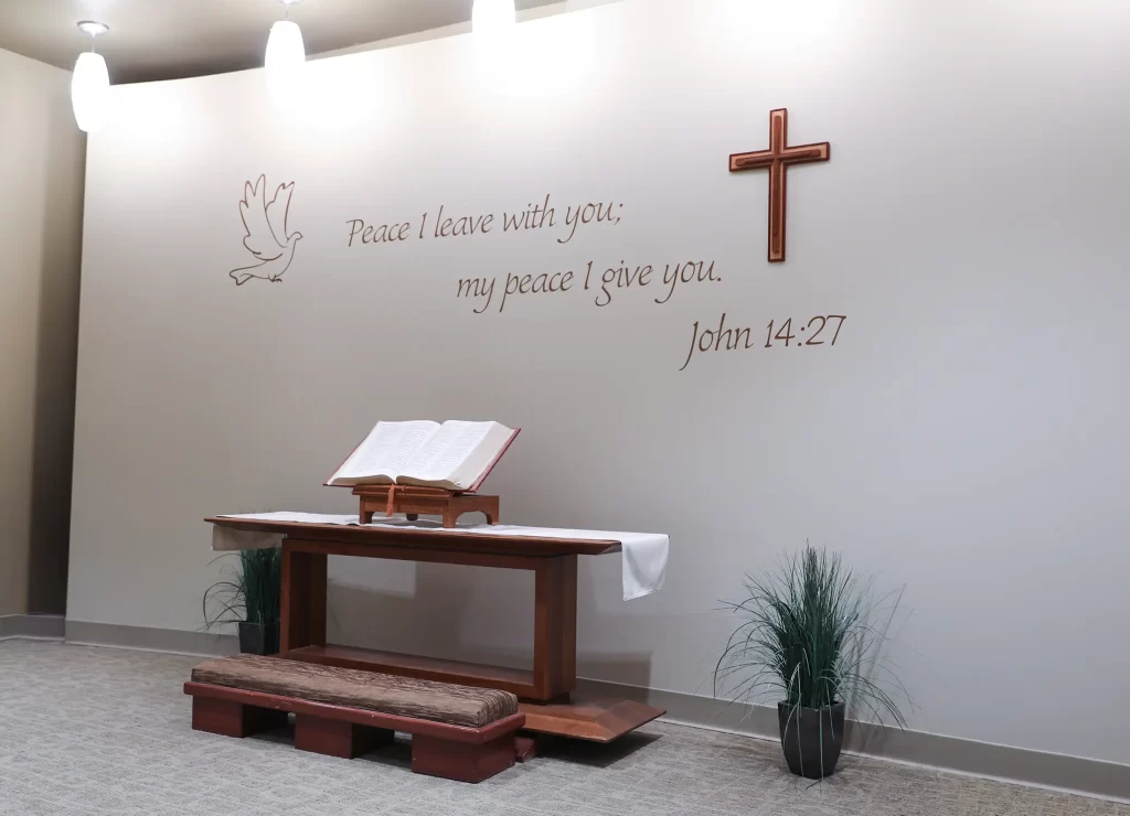 Hospital chapel with Bible, cross, and message of peace offering a quiet space for reflection and prayer